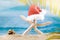 White starfish with Santa Claus`s hat with cone on beach behind sea. Christmas, New Year card