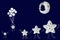 White stars family hold hands and walking under sleeping moon, small star flies with balloons on navy blue background