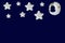 White stars and sleeping moon in silver bonnet on navy blue background