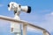 White stationary paid telescope on sea coast