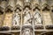 A white statue of Jesus holding a ball on the belfry tower of Ghent, Belgium, Europe