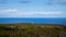 White statue standing on a ledge overlooking the ocean in the Cape Peninsula.