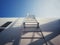 White steel ladder, on industrial wall background