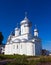 White steeple church with three domes