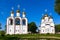 White steeple church with three domes