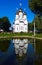 White steeple church with three domes