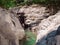 White stepped rocks with a bright turquoise river flowing into their gorge