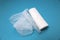 White sterile medical bandage on a blue background