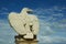 White stone eagle against the blue sky
