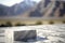 White stone podium made of stone, beautiful lanscape with mountains and blue sky on the background, platform for