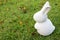 White stone rabbit statue on green grass