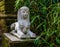 White stone sphinx statue in a garden, traditional egyptian decorations