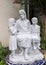 White stone statue of Saint Joseph and two children on a blue tile base at Saint Joseph Catholic School in Arlington, Texas.