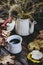 White stoneware espresso coffee cup and background with autumn leaves and a bouquet of dried flowers in autumn colors