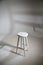 White stool with shadow on white background. Location in studio with tabouret on white background