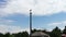 White stork sits in a nest on a pole on a summer day