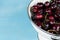 White strainer with cherries