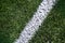 White stripe on a bright green artificial grass soccer field