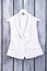 White striped women`s jacket on hanger.