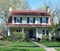 White Stucco House with Red Gambrel Roof