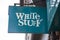 The White Stuff logo hanging from a shop in the UK