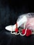 White stylish high heel shoe, pearl jewellery and red lipstick