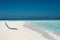 White sunbed near tropical calm beach with turquoise sea water and white sand. Maldives islands