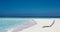 White sunbed near tropical calm beach with turquoise sea water and white sand. Maldives islands