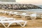 White sunbed on the sand beach at the sea, summer sea rest concept