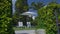 White sunbeds and sunshade standing in garden of private house, summer relax