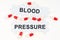 On a white surface, tablets and puzzles with the inscription - BLOOD PRESSURE