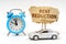 On a white surface there is a blue alarm clock, a car and a sign with the inscription - Rent reduction