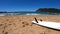 White surfboard on golden sand in Porto Ferro. Sardinia