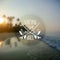 White surfing camp logo on blurred ocean sunrise