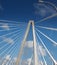 White Suspension Bridge Into Blue Skies