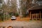 white suv car in autumn forest gazebo bbq place