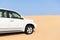 White SUV car in desert. Jeep safari in the sands