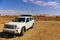 White SUV on a remote desert trail