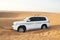 White SUV Toyota Land Cruiser in desert