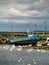 White swans in Corrib river, Galway city, by old fishing boats