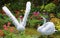 White swans decoy in spring garden
