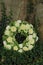 White sympathy wreath near a tree