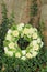 White sympathy wreath near a tree