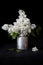 White Syringa flowers in an old milk can