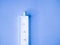 White syringe on a blue background. Syringe on blue background. 5ml syringe on blue background. Medical equipment for subcutaneous