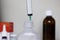 White syringe inside medicine bottle