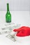 On white table bottle, christmas hat and money