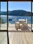 White table and chairs with glass door in the sea background