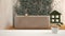 White table top or shelf with green plant in pot shaped like house, japanese bathroom, garden with ivy and bathtub in the