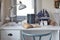 White table with wooden chair books and lamp in modern working area